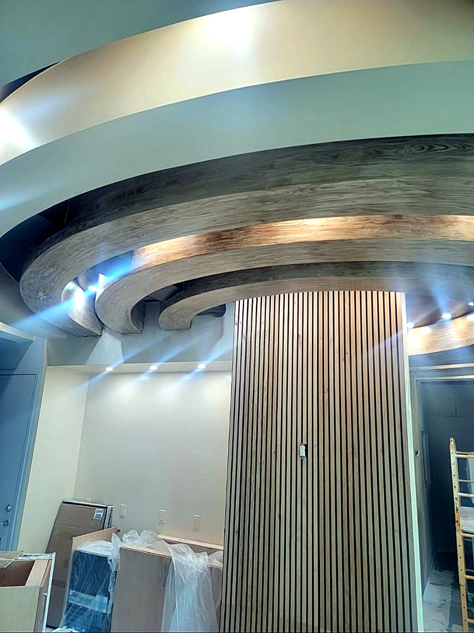 Second view of a surface transitioning from its painted base to a finished faux wood grain