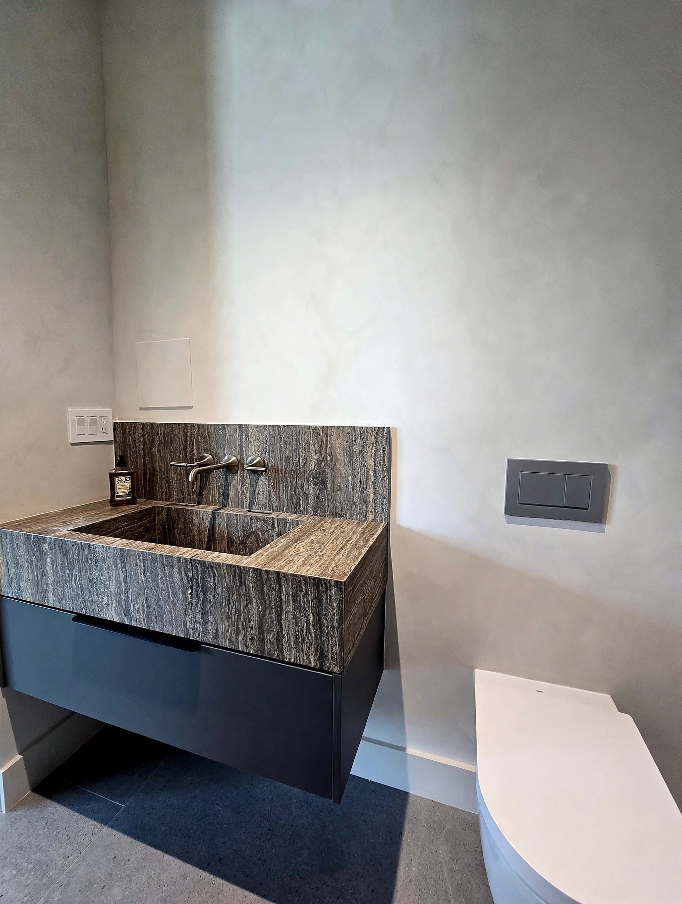 Bathroom finished in warm, softly mottled limewash