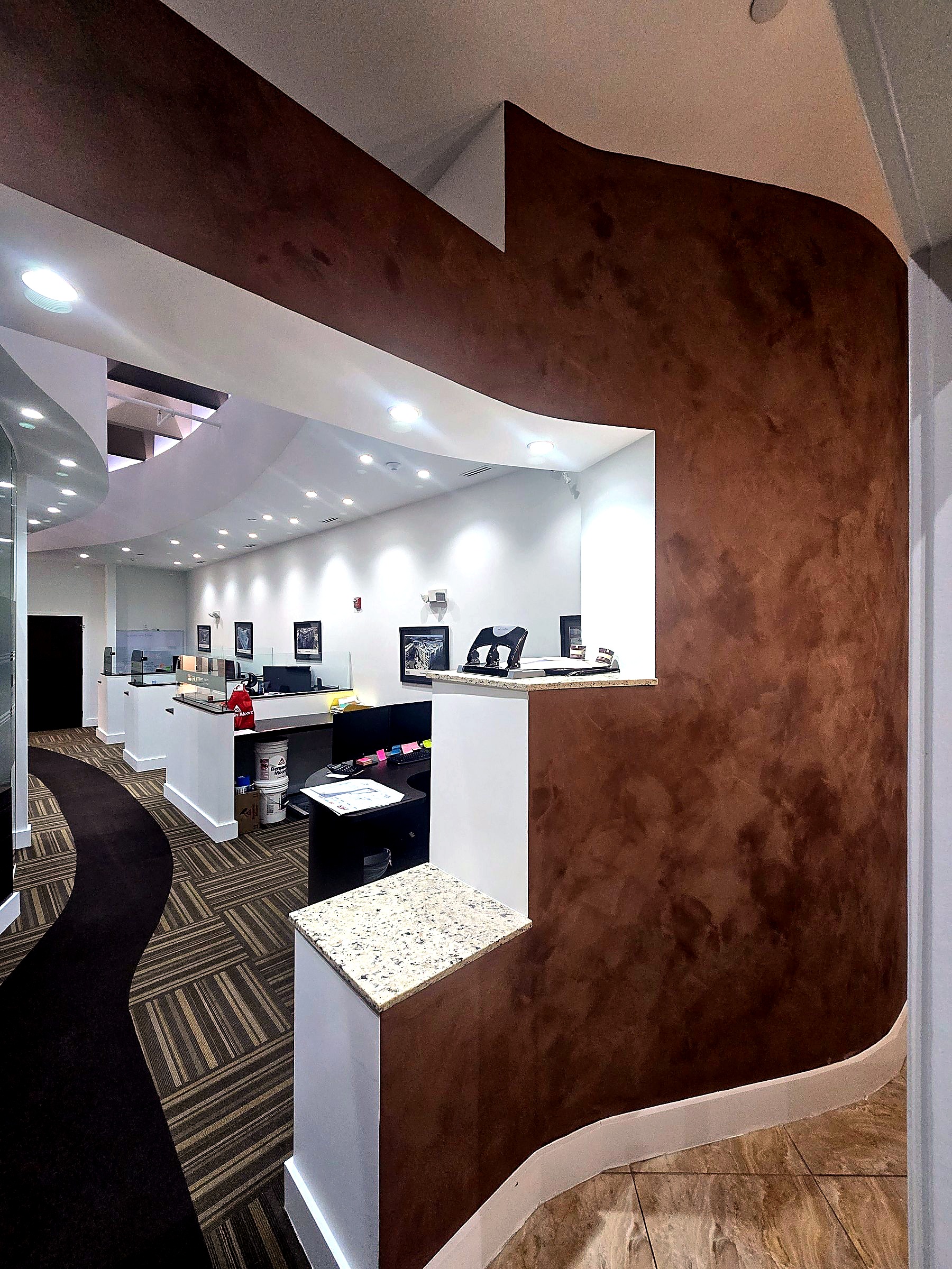 Office feature wall in a deep brown limewash finish