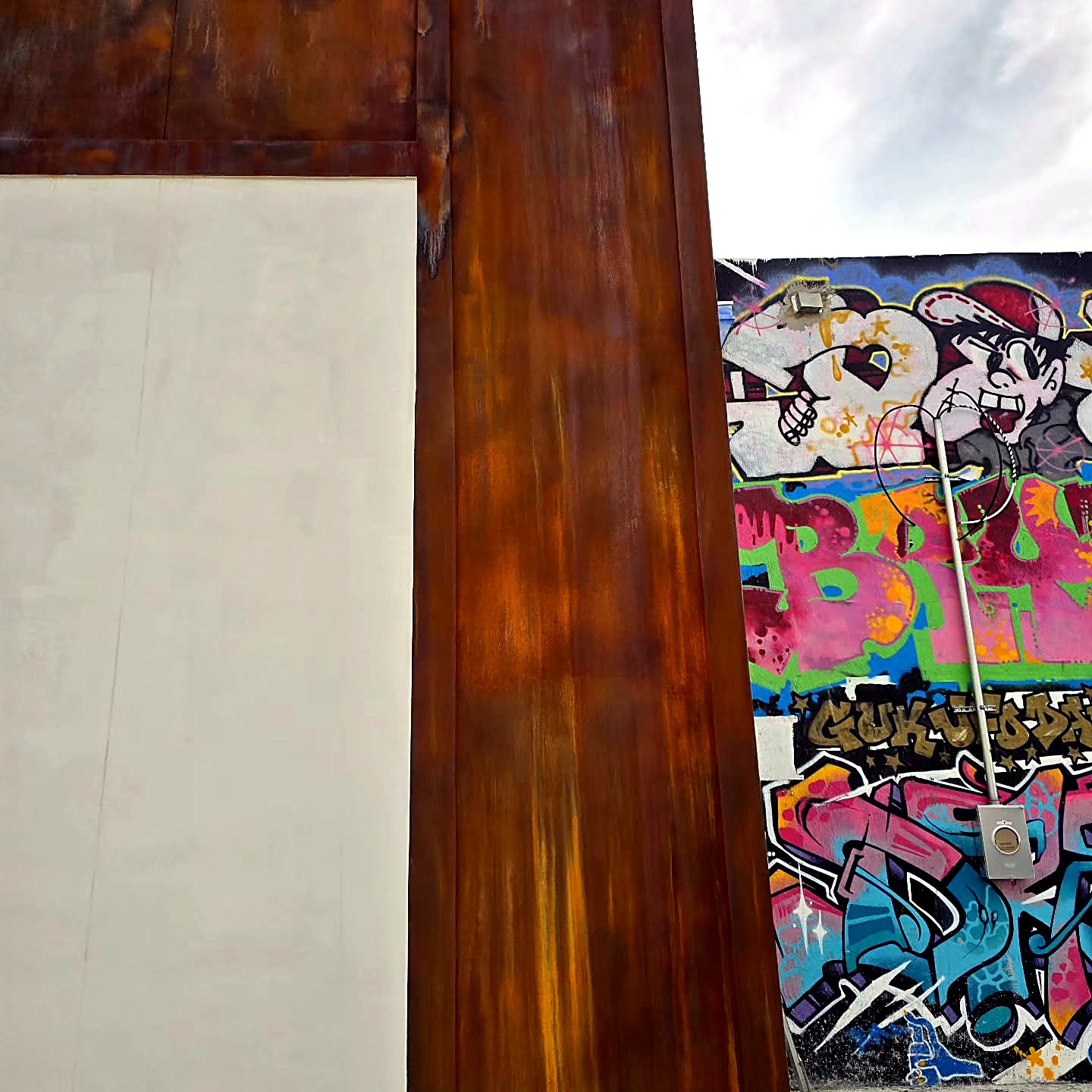 Final street view of the corten-inspired commercial facade