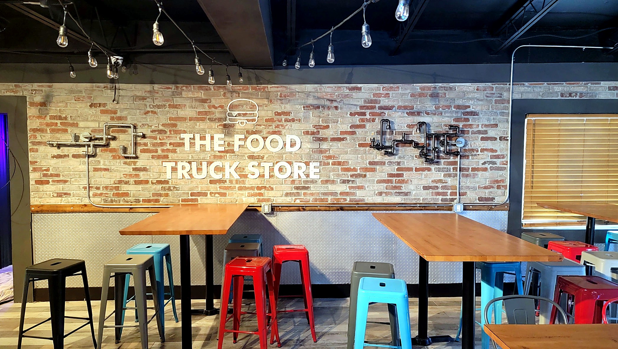 Food-truck store interior with brick wall panels and dimensional signage