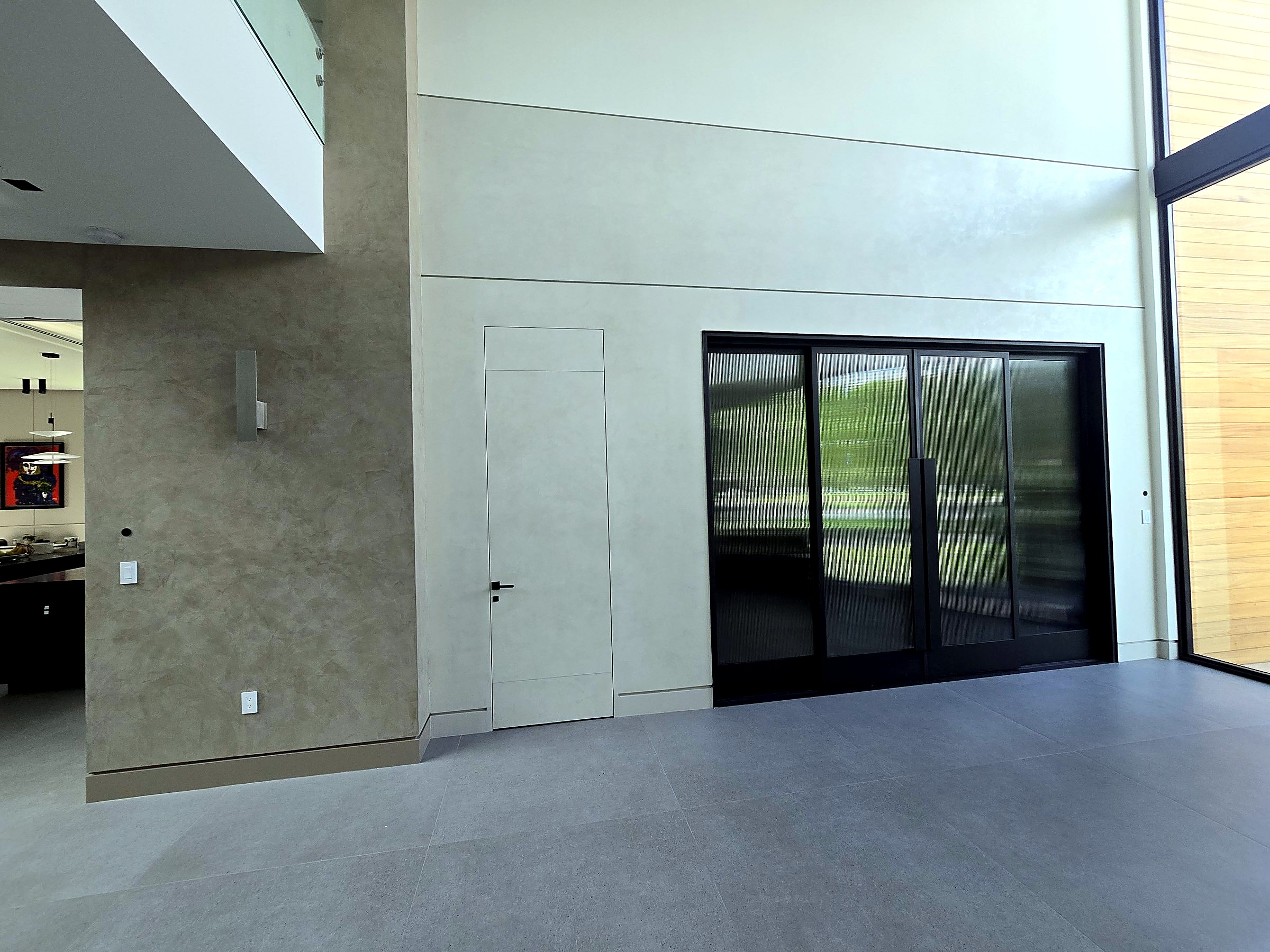 Double-height hall with hand-applied Venetian plaster walls