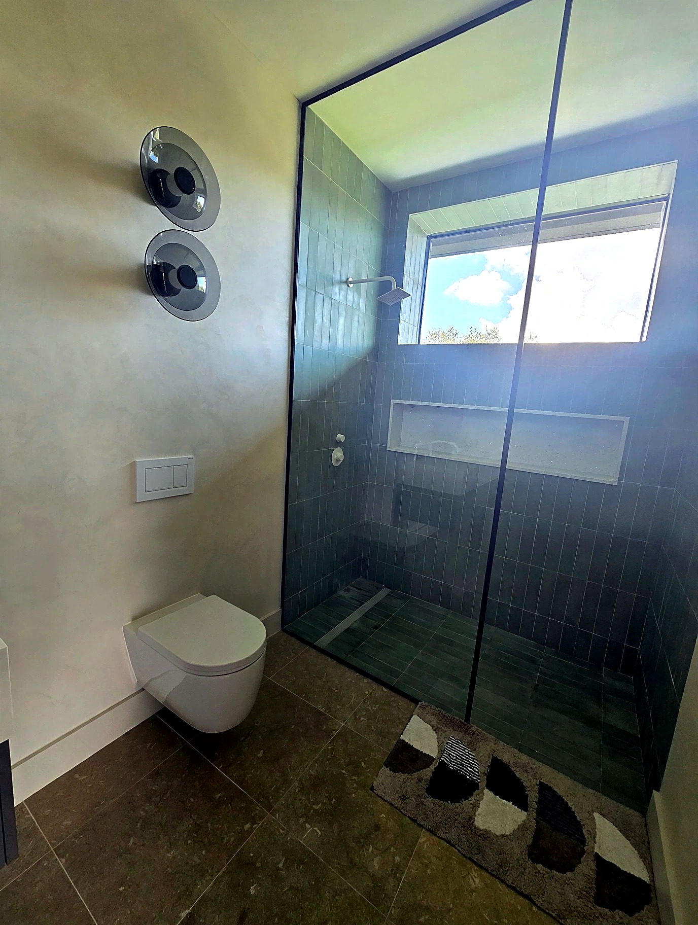 Shower walls finished in luminous Venetian plaster