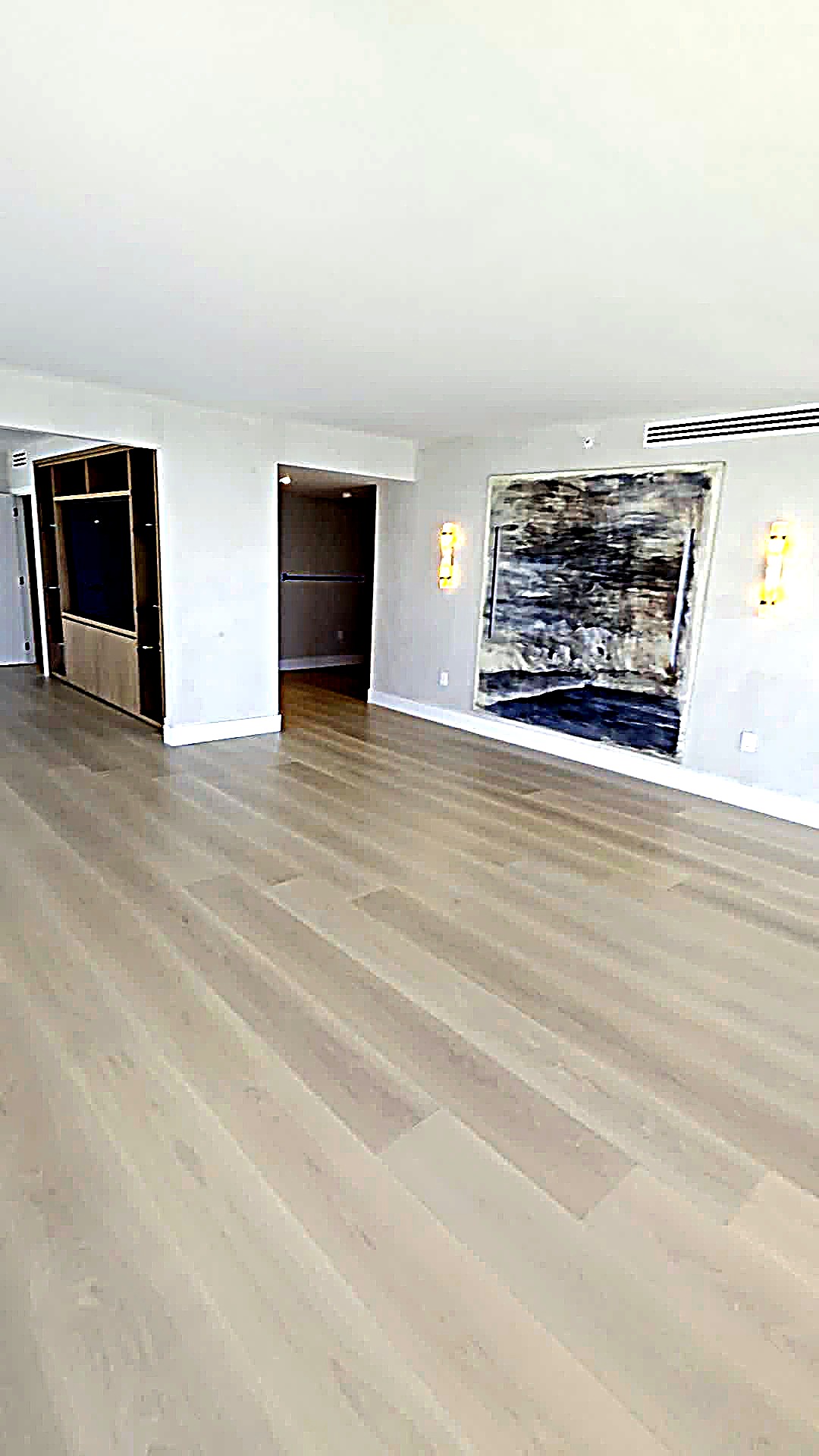 Living room with a large artwork and softly textured limewash wall